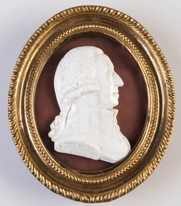 White vitreous / glass paste profile head-and-shoulders right-facing profile portrait bust of Adam Smith by James Tassie; incised inscription and signature in the truncation: 